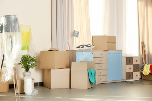 Furniture removals team handling large items in a Bermondsey apartment building