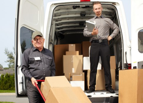 Staff lifting and carrying furniture using correct manual handling techniques