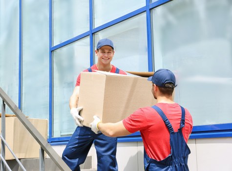 Mover carrying boxes in a Bermondsey apartment building